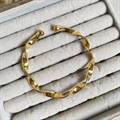 Gold-polished Twisted Bangle by Collection de Euphoria